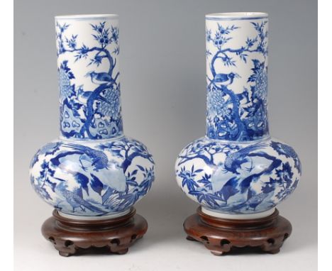 A pair of Chinese porcelain blue and white vases, probably Kangxi (1662-1722), each well decorated with birds amidst flowerin