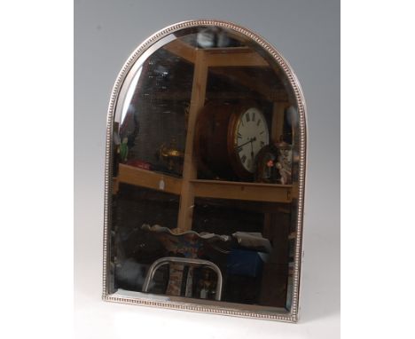 A 19th century Old Sheffield Plate dressing table mirror, the bevelled arched plate in a beaded surround, with brass easel ar