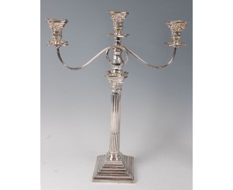A silver Corinthian column three light candelabrum, having beaded detachable sconces, the stop-fluted column with embossed ca