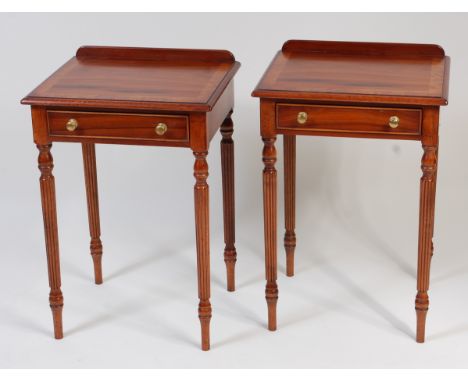 A pair of walnut and crossbanded ledgeback single drawer lamp tables, each raised on reeded and turned supports, h.73.5cm, w.