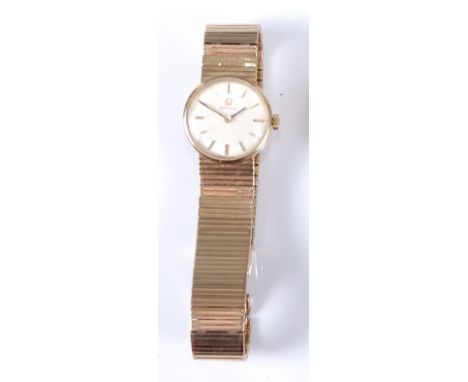 An Omega lady's 9ct gold cased bracelet watch, having a signed champagne dial with baton markers, manual wind movement, case 