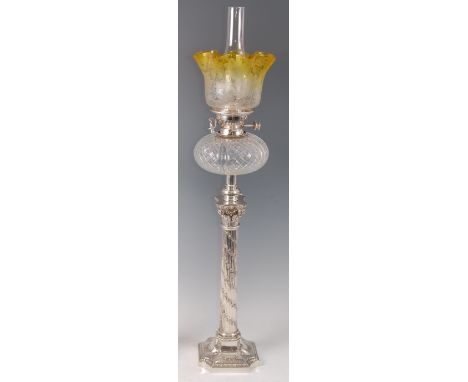 A composition column silver plated pedestal oil lamp, having a yellow tinted acid etched and floral decorated handkerchief sh