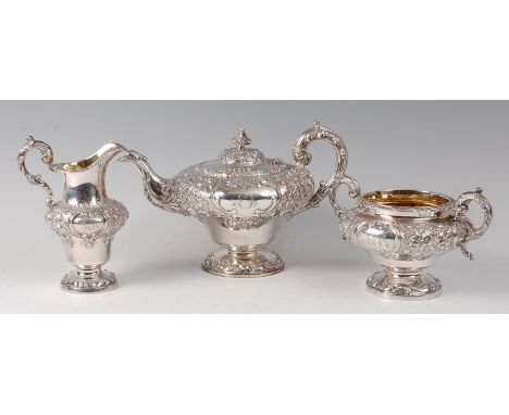 An early Victorian silver pedestal teapot and near-matching twin handled sugar and pedestal cream jug, the teapot having all-