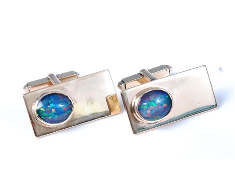 A pair of 9ct gold opal set cufflinks, the oval opal cabochons in rubover mounts, with closed back settings, in rectangles of