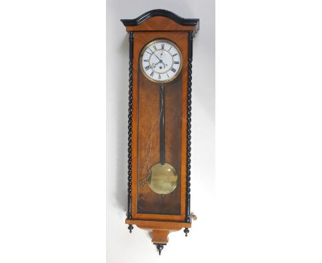 A circa 1900 walnut cased Vienna wall clock, having unsigned white enamel dial, subsidiary seconds dial, weight driven eight 