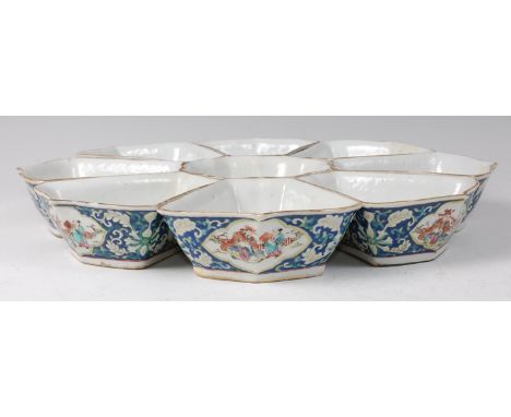 A 19th century Chinese porcelain hors d'oeuvres set of dishes, arranged as a centre bowl within a surround of eight individua