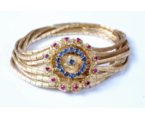 A mid 20th century 18ct Italian ruby and sapphire jarretière bracelet, the nine bands of textured close fitting links fitted 