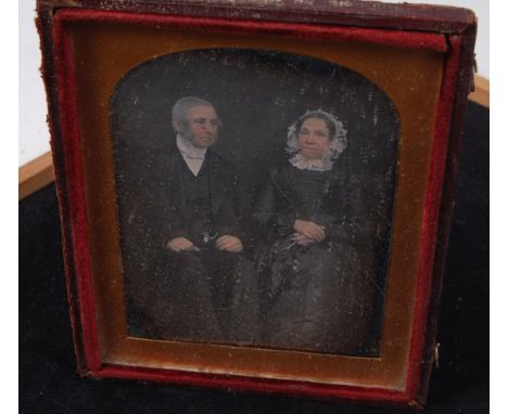 An early Victorian daguerreotype, depicting a family group before a makeshift home, in fitted leather and velvet-lined case, 
