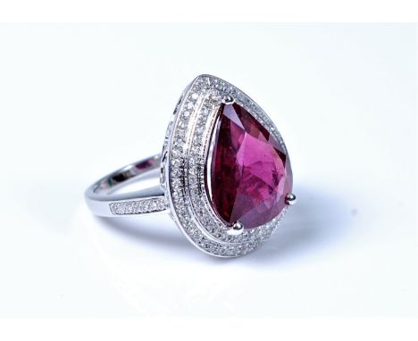 A treated ruby and diamond ring,  pear shaped treated ruby, approx. 14.8 x 11.5mm, claw mounted and surrounded by two stepped