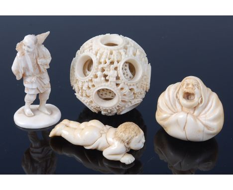 A circa 1900 Chinese Canton carved ivory puzzle-ball, dia. 5.2cm; together with a Japanese carved ivory okimono of a tradesma