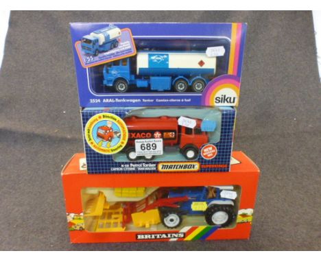 Three boxed diecast models to include Matchbox Superkings K-131, Siku ARAL-Tankwagen (2524) and Britains Ford 5610 Tractor an