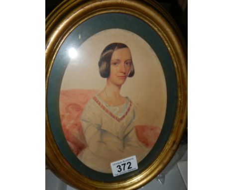 An oval framed and glazed watercolour portrait of a lady