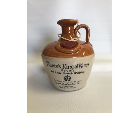 A bottle of Munro's 'King of Kings Rare Old Deluxe' Scotch whisky. 