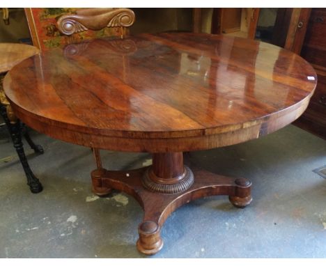 A mid 19th century rosewood tilt top dining table on turned pedestal and platform base, diameter 129cm. 