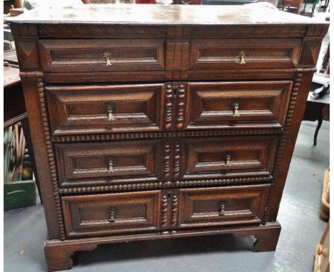 A late 17th/early 18th century oak chest of drawers, the moulded top over four graduated mitre moulded drawer fronts, the low
