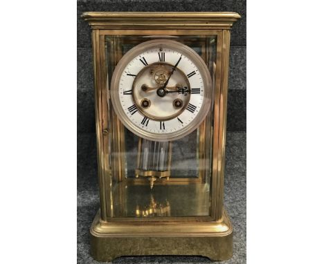 A late 19th century brass case mantle clock with two train French movement, mercury filled pendulum striking on a bell with w