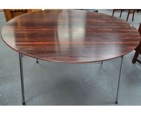 A mid 20th century Danish rosewood dining table by Fritz Hansen raised on four chrome metal legs, width 122cm.