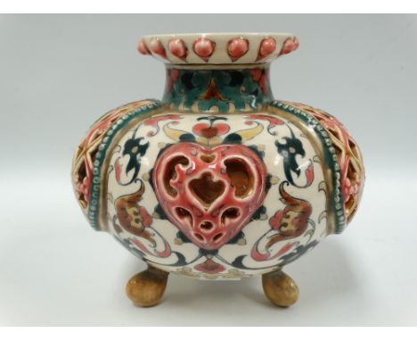 A Zsolnay Pecs ovoid reticulated vase raised on triple feet and with foliate scroll decoration, printed marks to the base, he