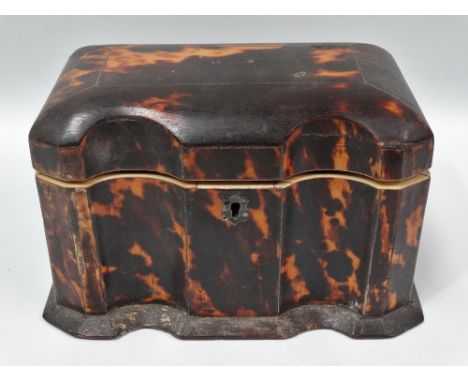 A Georgian tortoiseshell and ivory tea caddy, with serpentine front, the hinge lid revealing two lidded sections, width 17.5c