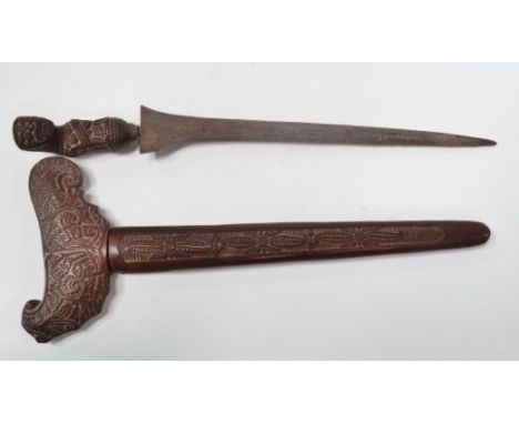 A good Javanese kris with watered steel blade, the hilt carved as a grotesque figure, the guard carved with foliate scrolls a