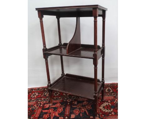 A mahogany side table fitted with three shelves on cabriole feet, height 86cm. 