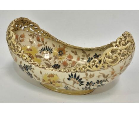 A Zsolnay Pecs pottery boat shaped vase with pierced foliate scroll rim and with foliate decoration with gilt highlights, blu