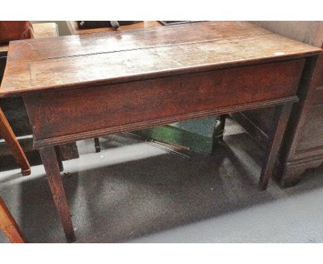 A George III oak rent table with rising top on square section tapering legs.