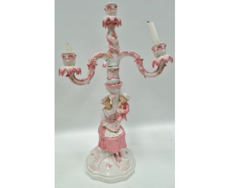 A German porcelain four branch candlestick with mother and child figural base, underglaze blue JR mark to the base, height 48
