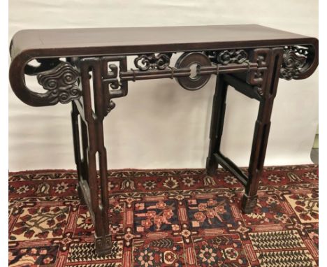 A 19th century Chinese hardwood altar or centre table of typical form with geometric and cloud carving to the frame, pierced 