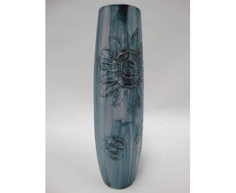 A Carn Pottery Penzance vase tubline decorated with a stylised sunflower, height 28cm. 