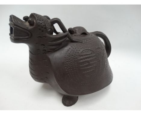 A large 20th century Chinese Yixing teapot, modelled as a mythical creature, the body with archaic script, the lid with turtl