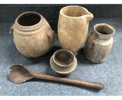 Four African carved wood pots and a spoon. 
