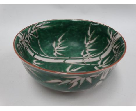 A Chinese green ground bamboo decorated bowl, red painted seal mark to the base, diameter 18cm. 