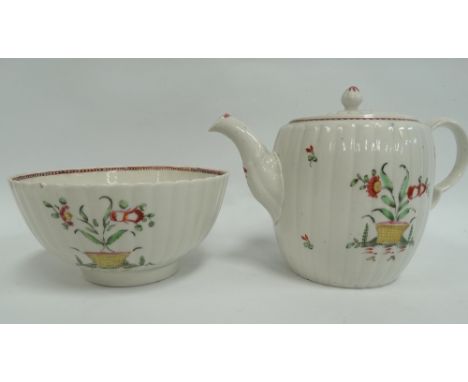 An 18th century ovoid fluted teapot with polychrome floral painted spray decoration, height 14cm, together with matching slop