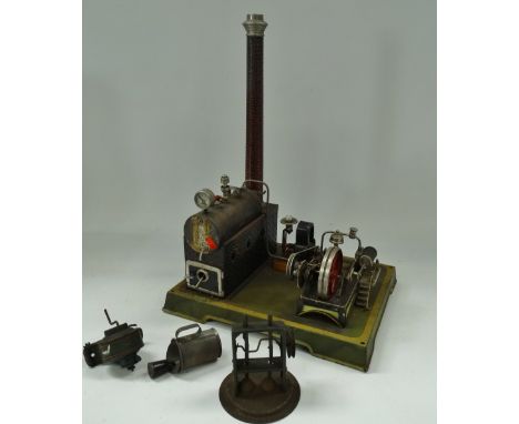 An early 20th century tin plate stationary steam engine, currently connected to an electric motor, together with some ancilla