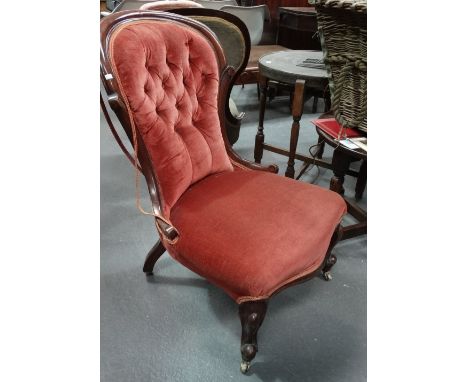 A Victorian mahogany framed and upholstered occasional chair with cabriole legs and button back. 