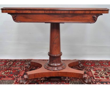 A mid 19th century rosewood card table with swivel top, turned column support and platform base. 