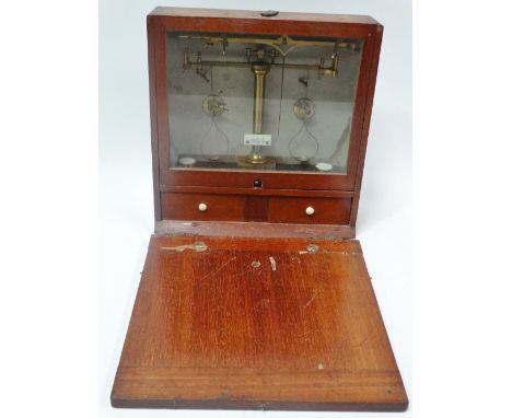 An early 20th century mahogany cased miniature balance scales with ivory scales, signed C. Wolters &amp; Son London, the case