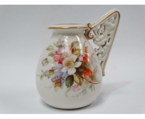 A Royal Worcester vase with reticulated floral scroll moulded single handle, No.1137, puce printed marks to the base and RD N