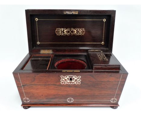 A William IV rosewood mother of pearl inlaid sarcophagus form tea caddy, the hinge lid enclosing two lidded compartments (one