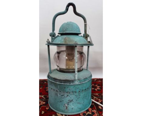 A copper ship's masthead lamp, converted to electricity, height 42cm, together with a wrought iron hanging bracket. 