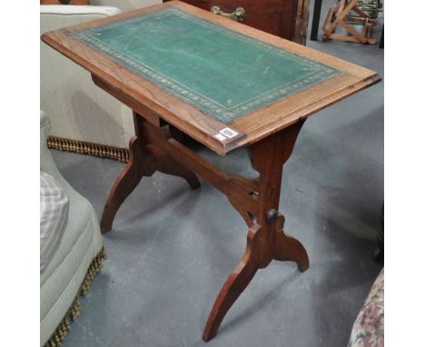 An early 20th century oak and leather topped occasional table of rectangular form. 