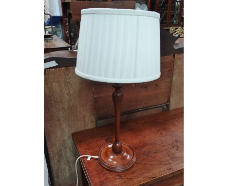 A turned mahogany electric lamp base. 
