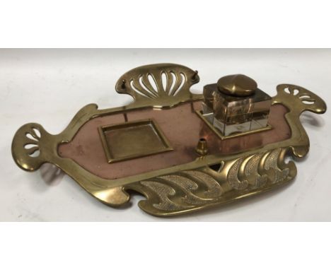 An early 20th century copper and brass Secessionist desk stand with one glass cubed inkwell (the other inkwell missing), widt