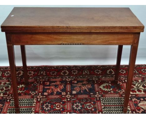 A George III mahogany and strung tea table with square section tapering legs and banded inlays, width 90cm.