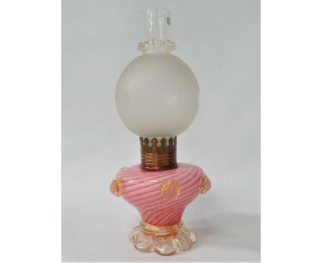 A white opaque and pink air twist glass oil lamp base applied with prunts and on an outswept clear foot and with frosted glas