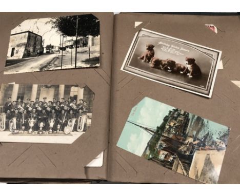 An early 20th century postcard album with mainly greetings cards, some portrait and Cornish topographical.