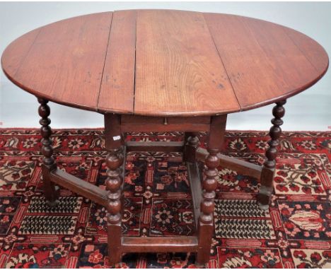 An 18th century oak bobbin turned drop leaf dining table fitted a single drawer, width 92cm.