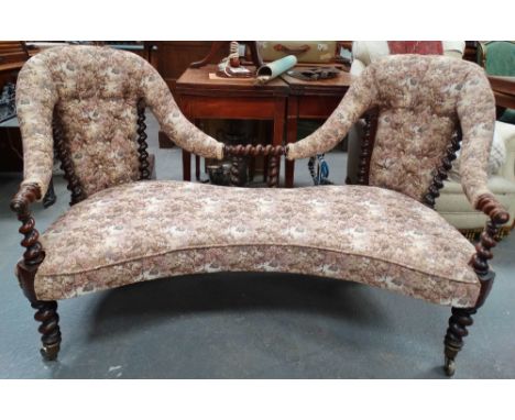 A late 19th century twin seater sofa with button back upholstery and spiral turn framed structure with brass cup castors. 