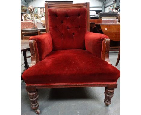 A late 19th century walnut framed salon armchair with turned legs and button back upholstery. 